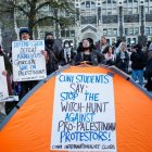La gente sostiene pancartas mientras manifestantes pro palestinos se reúnen en el campus del City College de Nueva York