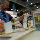 A person browses comic books on the first day of Comic-Con International at the San Diego Convention Center in San Diego, California, on July 24, 2024. (Photo by Chris DELMAS / AFP)