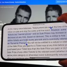 A section of Ticketmaster's purchase policy explaining "Dynamic Pricing" - found on the company's website - is highlighted on a phone, with the Tickemaster website displayed in the background, showing the options for purchasing Oasis tickets, in London. Picture date: Monday September 2, 2024.