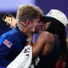 Gold medallist US' Hunter Woodhall (L) celebrates with his wife Olympic women's long jump champion Tara Davis-Woodhall after the victory ceremony for the Men's 400m T62 final event at the Stade de France in Saint-Denis, outside Paris on September 6, 2024. (Photo by Dimitar DILKOFF / AFP)