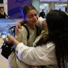 A fan of Maccabi Tel-Aviv is met by a family member at the Ben Gurion International Airport