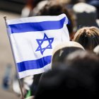 A flag of Israel is seen during a commemoration ceremony at the Bergen-Belsen Memorial in Lohheide, northern Germany on April 27, 2025, on the occasion of the 80th anniversary of the liberation of the Bergen-Belsen concentration camp. The Bergen-Belsen concentration camp was liberated by British forces on April 15, 1945. (Photo by FOCKE STRANGMANN / AFP)