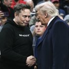 Tesla and SPaceX CEO Elon Musk and US President Donald Trump shake hands as they attend the men's NCAA wrestling competition at the Wells Fargo Center in Philadelphia, Pennsylvania, on March 22, 2025. (Photo by Brendan SMIALOWSKI / AFP) / ALTERNATE CROP