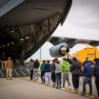 A group of illegal immigrants board a plane to be deported