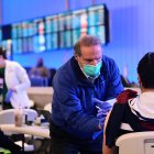 The Covid-19 vaccine is administered in the international arrivals section of Los Angeles International Airport