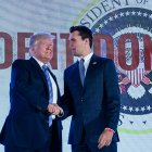 Donald Trump shakes hands with Charlie Kirk