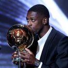 Paris Saint-Germain's French forward Ousmane Dembele kisses the Ballon d'Or award during the 2025 Ballon d'Or France Football award ceremony at the Theatre du Chatelet in Paris on September 22, 2025. (Photo by Franck FIFE / AFP)