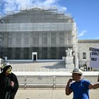 Demonstrators protest outside the US Supreme Court in Washington, DC, on November 5, 2025. The Supreme Court will hear arguments Wednesday on whether a wide swath of Donald Trump's tariffs are lawful, in a landmark case that could uphold -- or upend -- the president's economic agenda. Billions of dollars in customs revenue and a key lever in Trump's trade wars are at stake, while the conservative-dominated court once again grapples with novel tests of presidential authority. (Photo by Mandel NGAN / AFP)