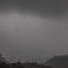Heavy rain is seen from Kenneth Hahn Park blocking the view of the city skyline on December 24, 2025 in Los Angeles, California. A major winter storm rolled into California on December 23, forcing hundreds of evacuations in burn areas while threatening flooding and travel delays through Christmas for much of the state, officials said.
A "strong atmospheric river brings heavy rain, snow, and wind to California through Friday," the National Weather Service said in a statement on December 23, warning anyone in northern, central and southern parts of the state to "exercise extreme caution." (Photo by Apu GOMES / AFP)