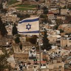 An Israeli flag flutters in the wind over the Arab East Jerusalem neighbourhood of Silwan