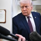 US President Donald Trump speaks to reporters while in flight on Air Force One, traveling from Shannon, Ireland en route Joint Base Andrews in Maryland on January 22, 2026. Trump is returning from Davos, Switzerland after attending the World Economic Forum. (Photo by MANDEL NGAN / AFP)