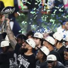 Seattle Seahawks' players celebrate with the Vince Lombardi Trophy after defeating the New England Patriots during Super Bowl LX at Levi's Stadium in Santa Clara, California on February 8, 2026. (Photo by Patrick T. Fallon / AFP)