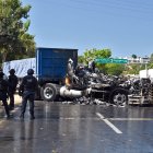 Firefighters extinguish the fire of a truck that was set on fire on a street in the port of Acapulco, Guerrero state on February 22, 2026. The Mexican army announced the death of powerful drug lord Oseguera Cervantes, for whom the United States was offering a £12 million reward, adding in a statement that El Mencho was wounded in an operation carried out in the town of Tapalpa, in the western state of Jalisco, and died during his transfer by air to Mexico City. (Photo by Francisco ROBLES / AFP)