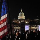 People hold signs as they attend the "People's State of the Union" at the National Mall in Washington, DC, on February 24, 2026. A group of senators and representatives are boycotting US President Donald Trump's State of the Union by holding their own rally. (Photo by Ken Cedeno / AFP)