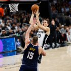 March 15, 2024: San Antonio Spurs forward Zach Collins (23) shoots the ball over Denver Nuggets center Nikola Jokic (15) during an NBA game on March 15, 2024.
