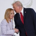 El presidente Trump dice algo al oído a la primer ministro de Italia Giorgia Meloni