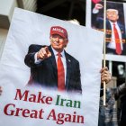 Demonstrators hold placards of US President Donald Trump with text that reads "Make Iran Great Again" during a rally supporting political change near the Iranian embassy in Tokyo on March 17, 2026. (Photo by Philip FONG / AFP)