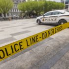 Police car vehicle of United States Secret Service and POLICE LINE- DO NOT CROSS ribbon.