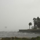 A house is battered by the strong winds and storm surge of Hurricane Isaias in Pensacola, Florida, on October 9, 2026. Hurricane Isaias' outer bands were lashing the US Gulf Coast with heavy rain and strong winds Friday, with the category 3 storm triggering mandatory evacuations and poised to bring life-threatening storm surge when it makes landfall. (Photo by RONALDO SCHEMIDT / AFP)