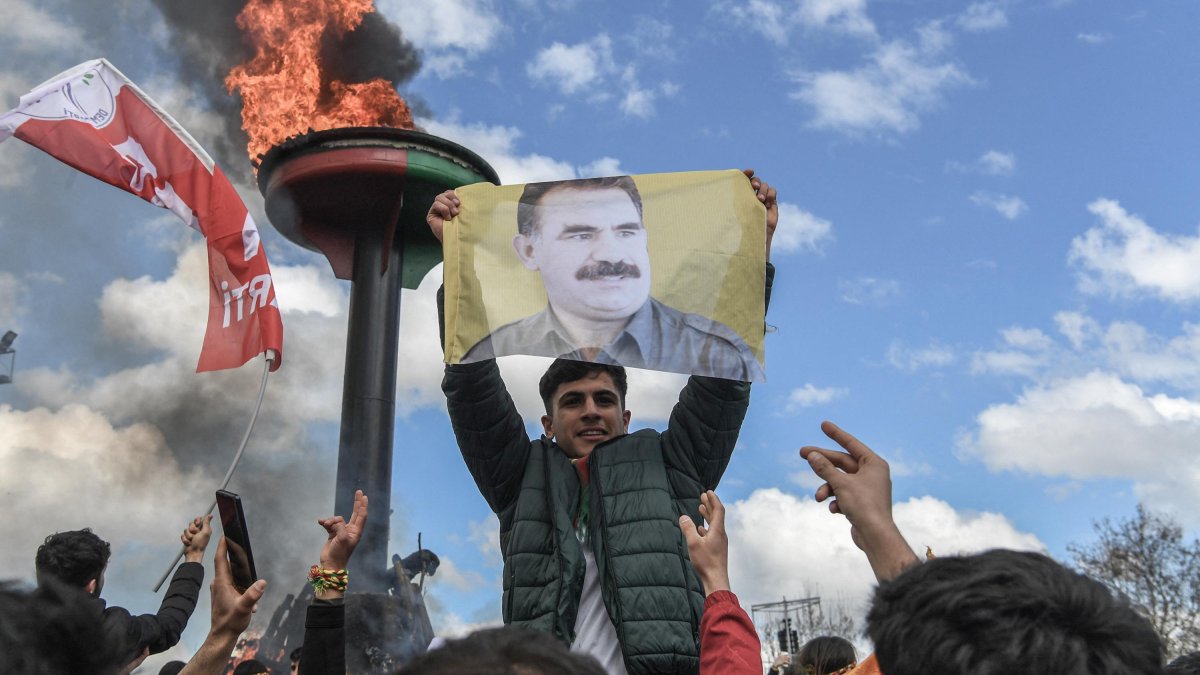 A man holds a portrait of PKK leader Abdullah Öcalan.