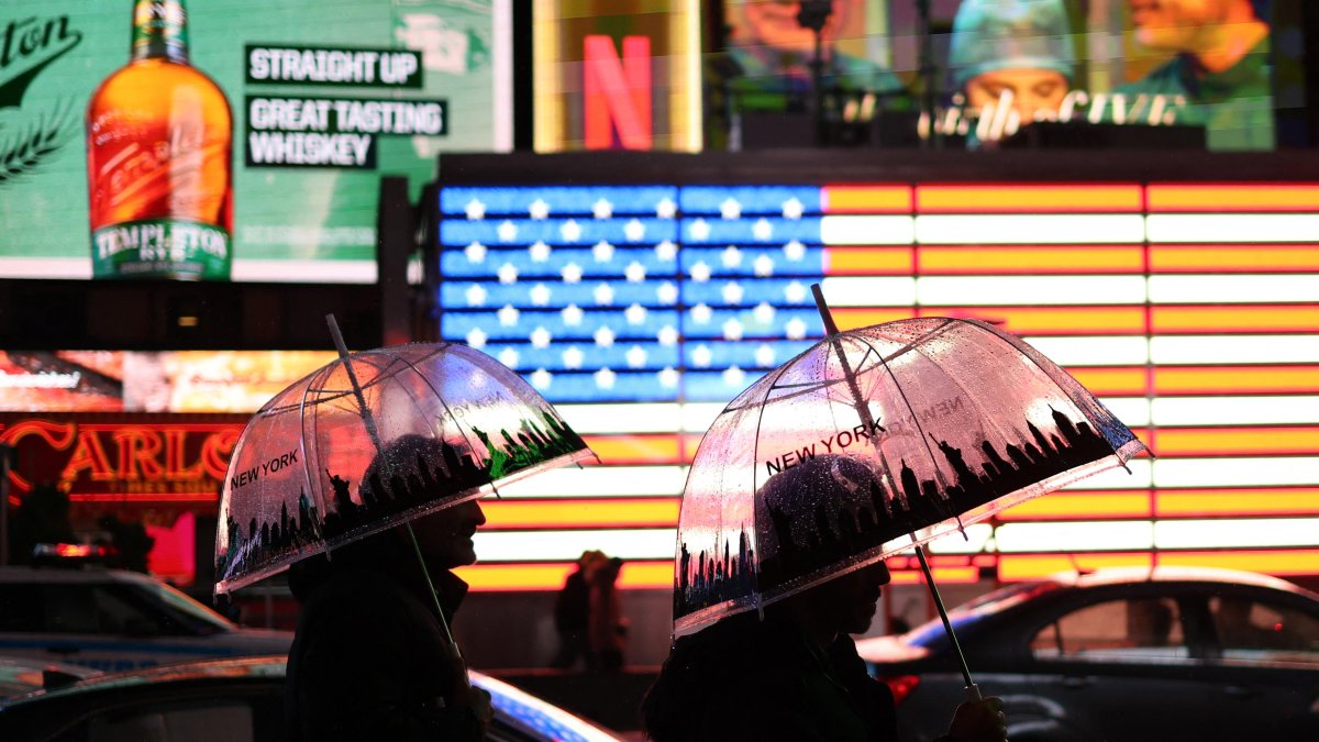 Two people walk through New York during a rainy day. File image