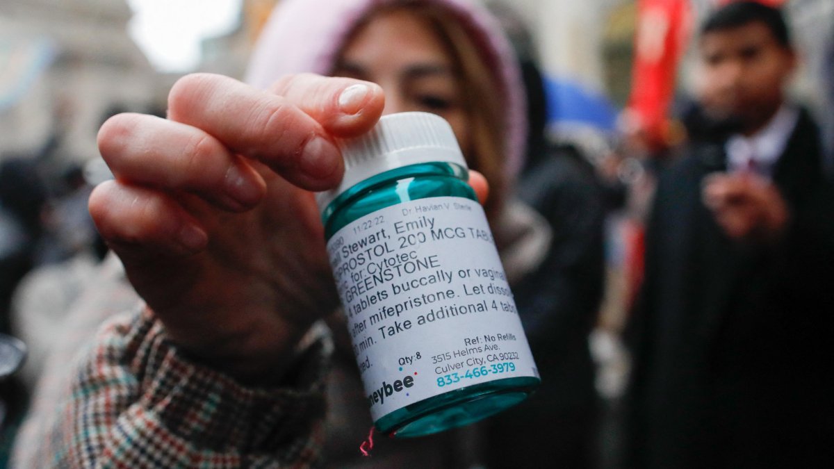 A pro-abortion activist with abortion pills in the middle of a protest (File).