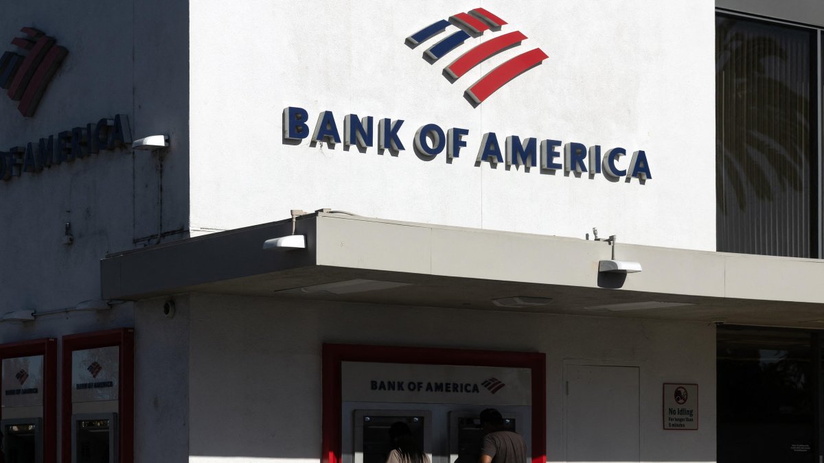 People use ATMs at a Bank of America branch