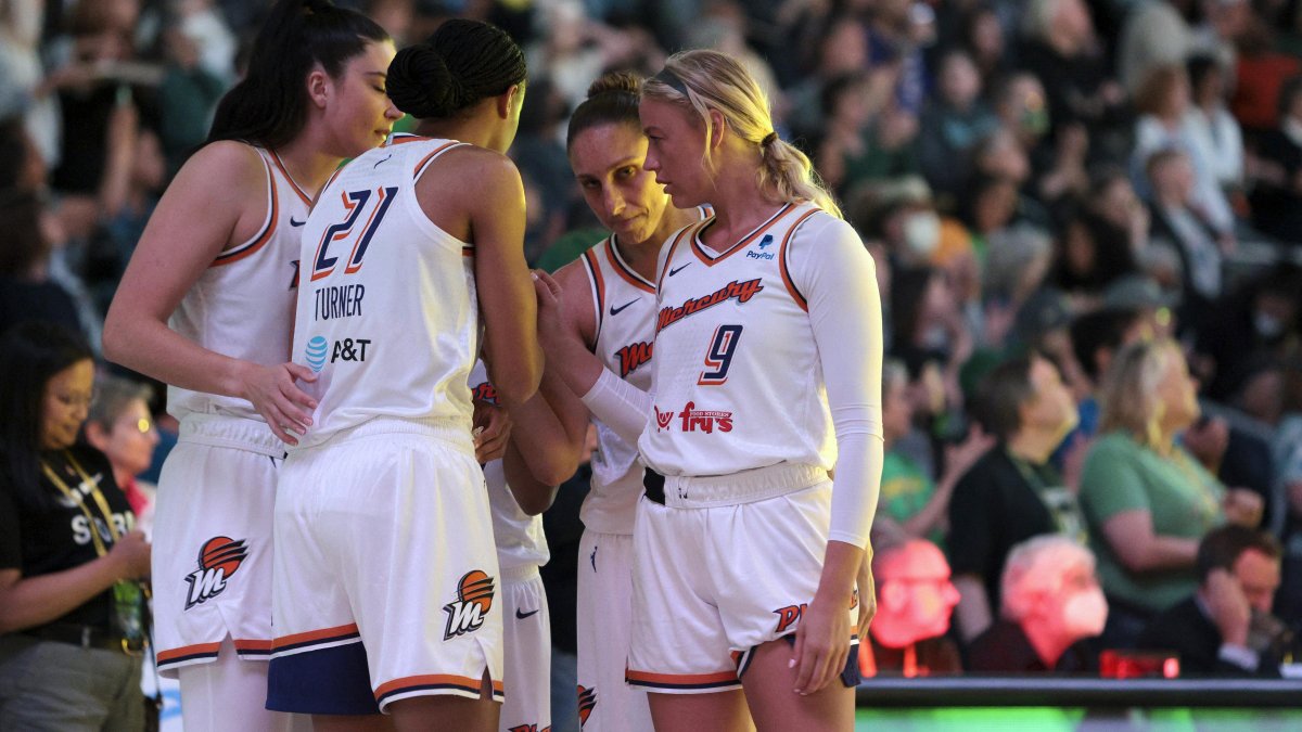 Sophie Cunningham (right) talks with teammates