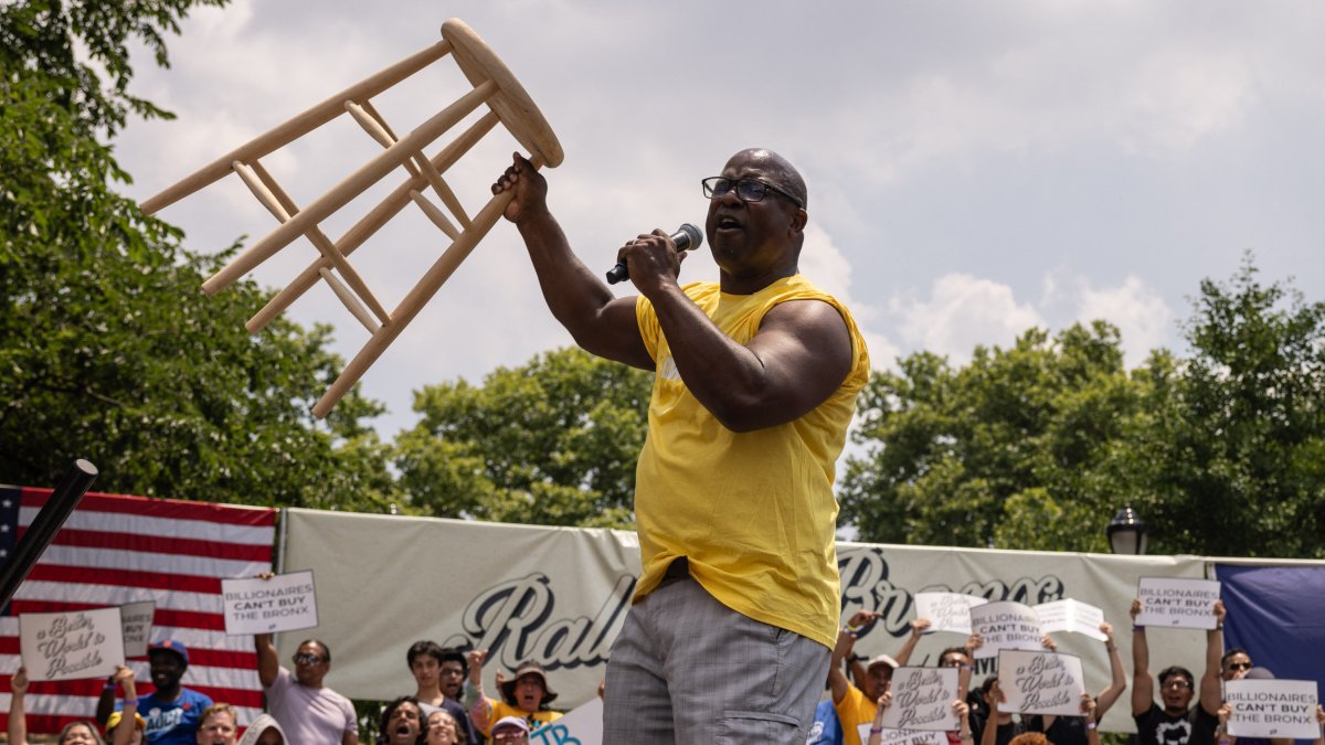 Democratic Rep. Jamaal Bowman raises a chair during a campaign rally on June 22.