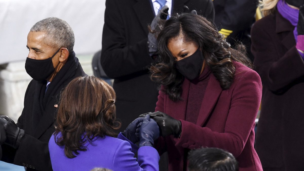Kamala Harris as vice president-elect being greeted by former first lady, Michelle Obama, during the presidential inauguration on January 20, 2021. (Photo by OLIVIER DOULIERY / AFP)