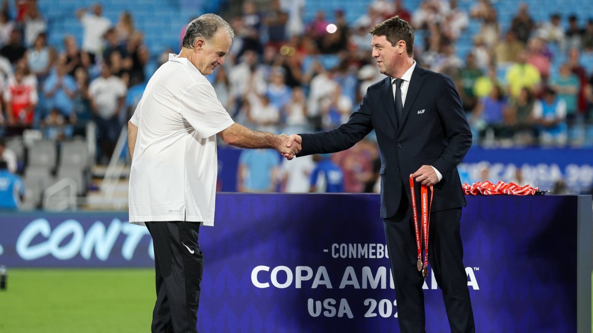 Marcelo 'el Loco' Bielsa accepts Copa America third-place medal.