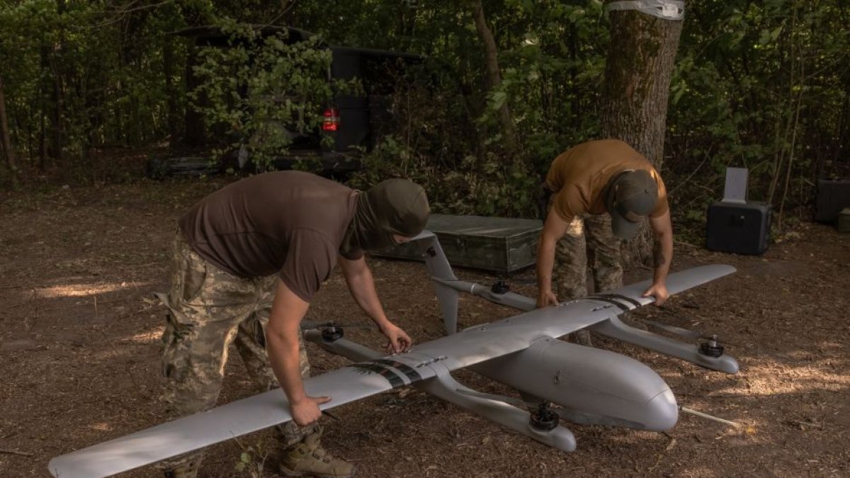 Ukrainian military drone operators assembling an unmanned aerial vehicle.