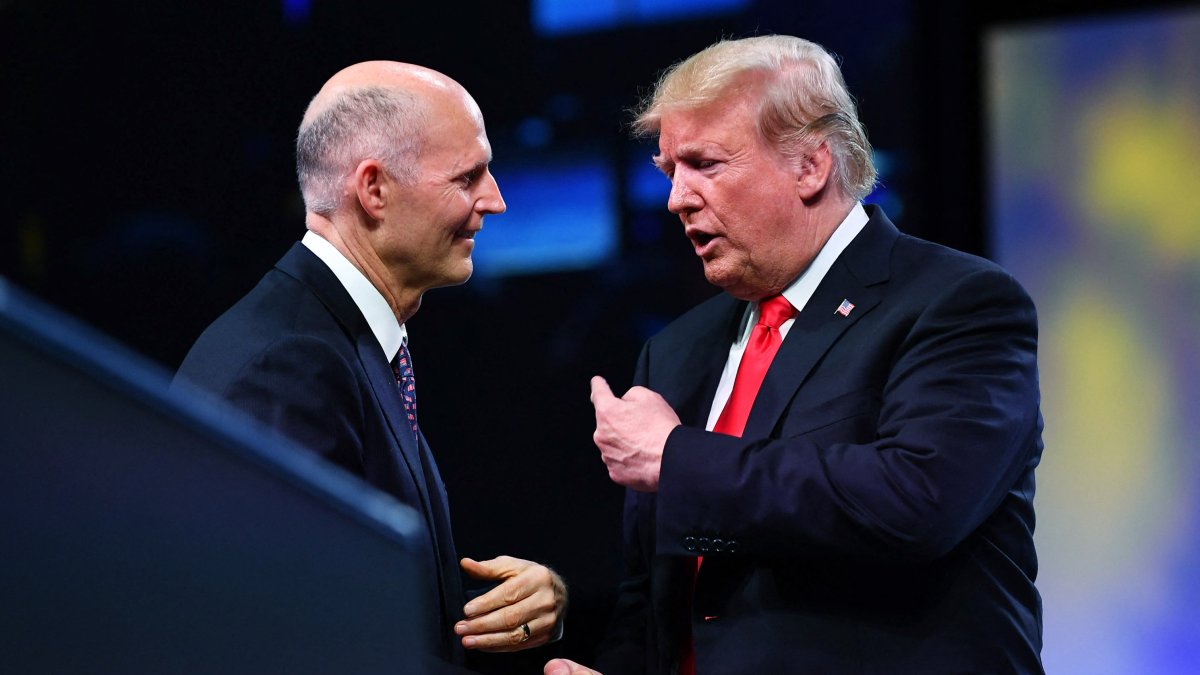 Donald Trump and Rick Scott shaking hands in a file photo