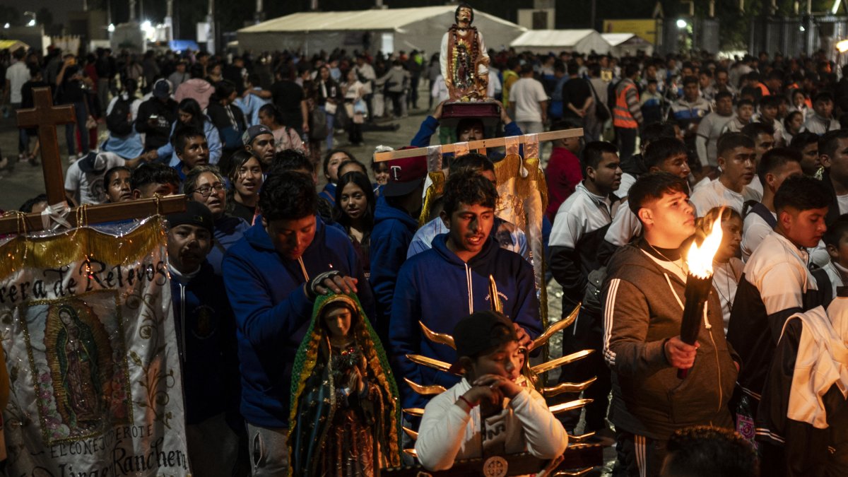 Pilgrims participate in the Eucharist in the Basilica of Guadalupe
