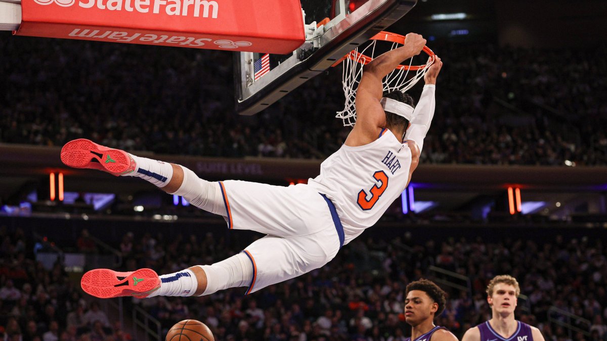 Josh Hart (3) Hangs on the basket after making a dunk.