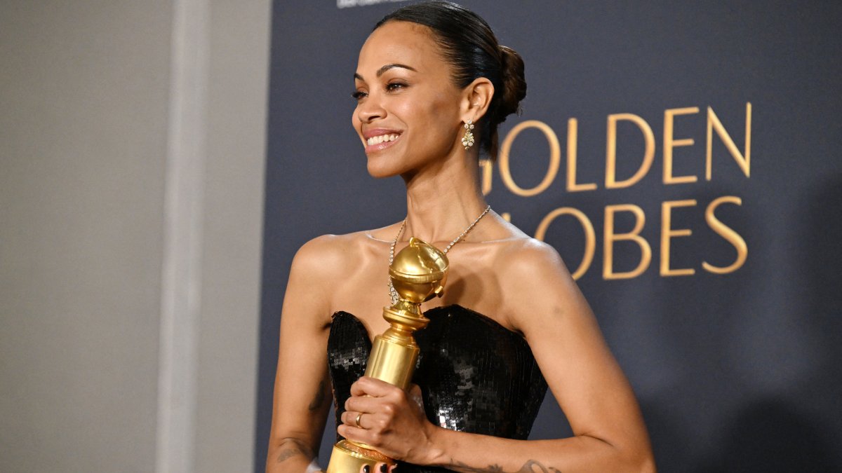 Actress Zoe Saldana poses with the award for her role in Emilia Perez.