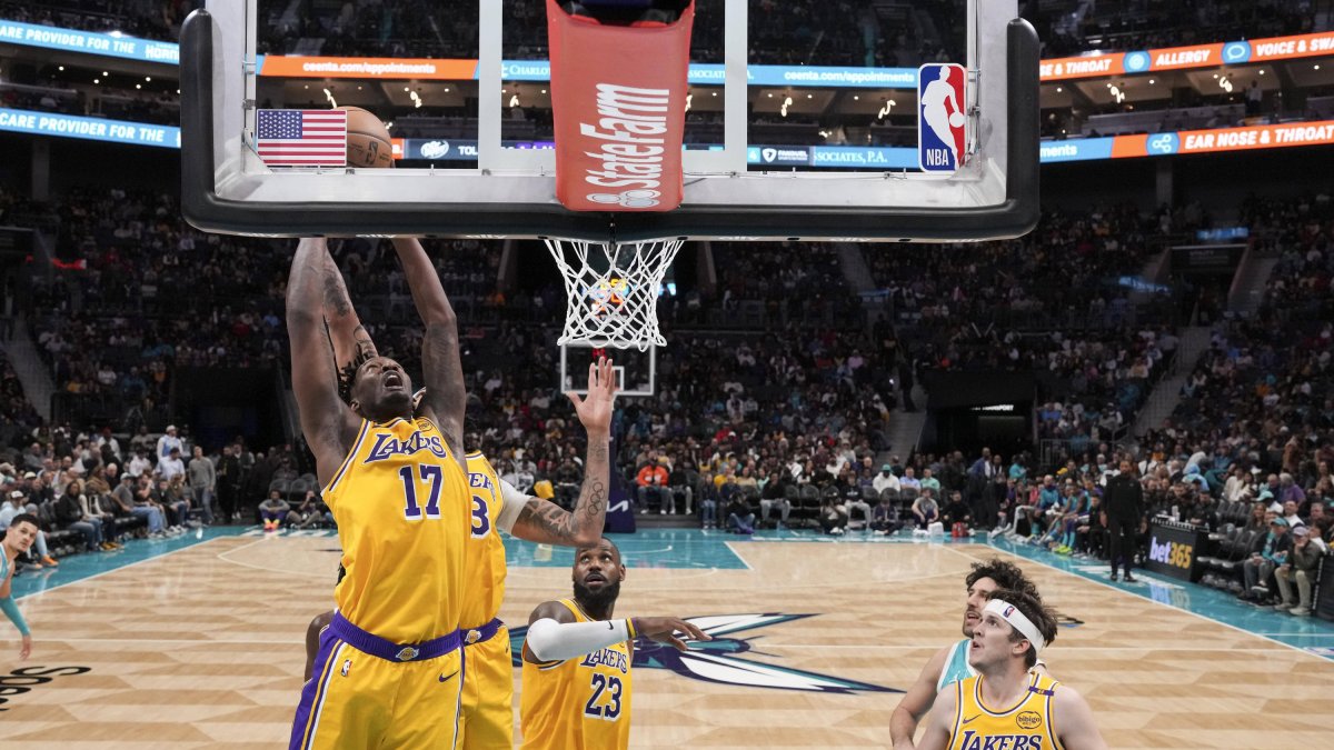 Lakers forward Dorian Finney-Smith (17) grabs the rebound at the rim.