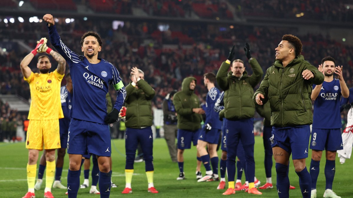 Paris Saint-Germain's Brazilian defender celebrates with teammates.