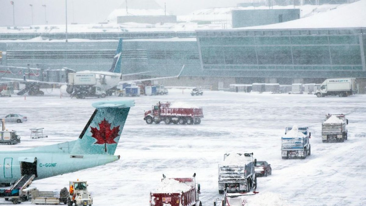 Trucks shovel snow from Pearson International Airport