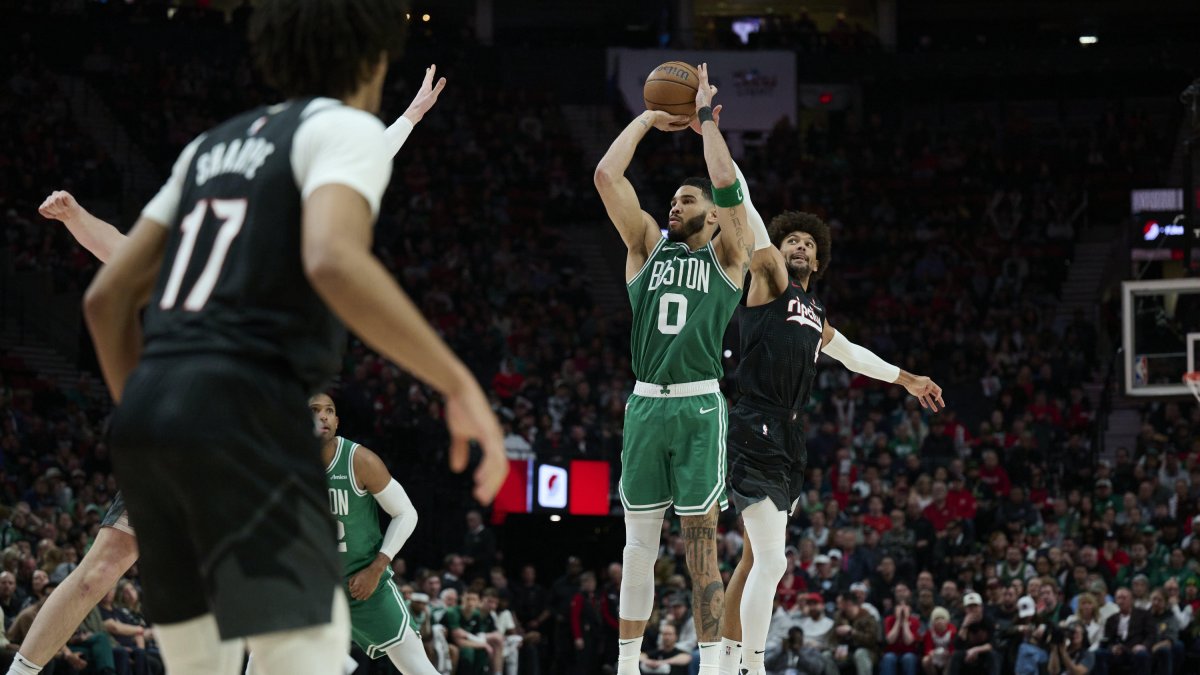 Jayson Tatum (0) drives to the basket.