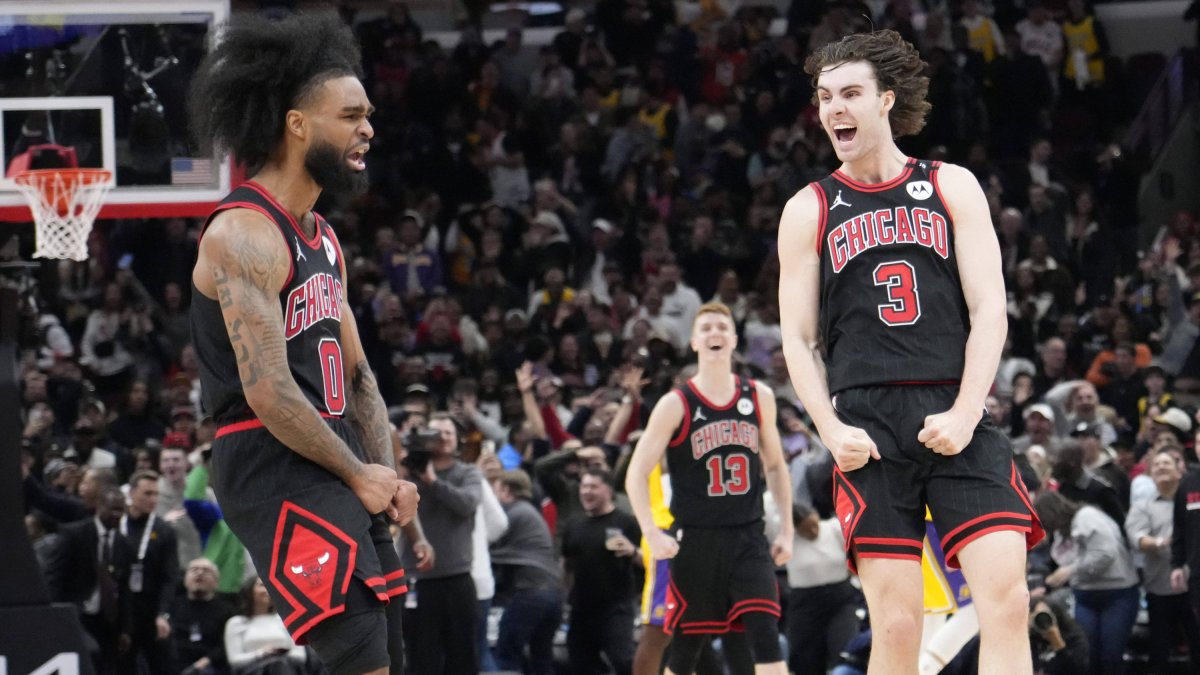 Coby White celebrates his 3-point basket against the Los Angeles Lakers with guard Josh Giddey.