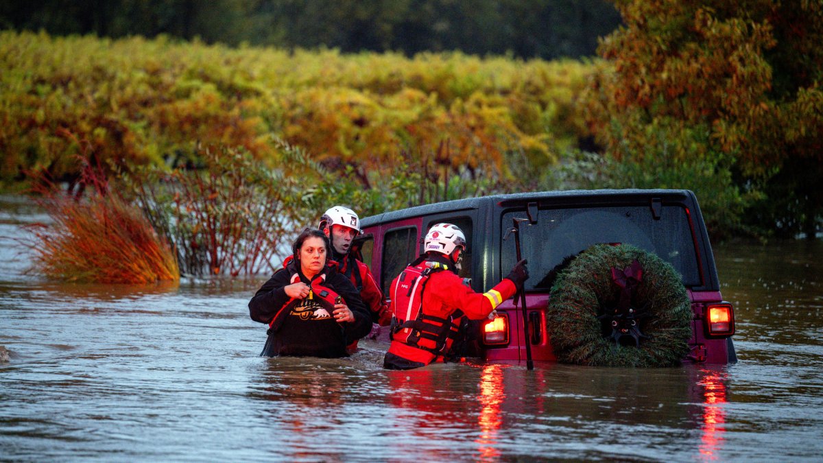 Firefighters rescue couple trapped in flooding in California