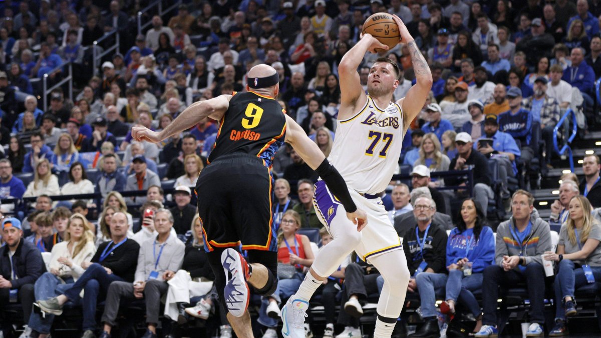 Doncic (77) lanza a canasta ante Alex Caruso (9)