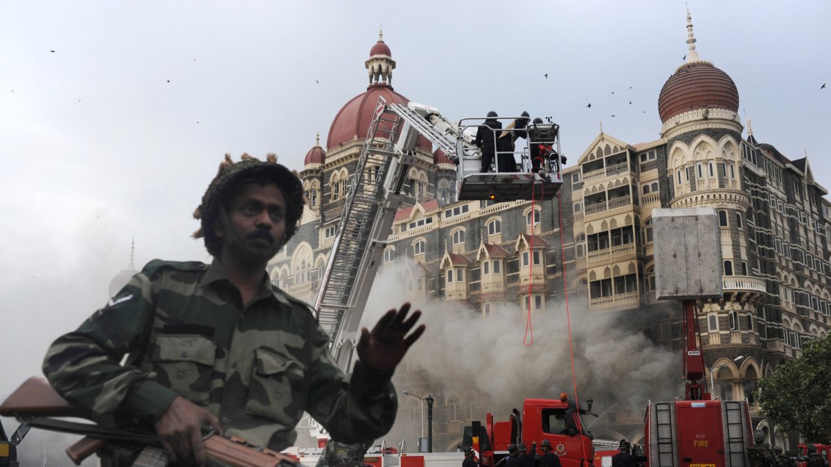 An Indian soldier stops people from approaching the Taj Mahal Hotel after a rescue operation in Mumbai.