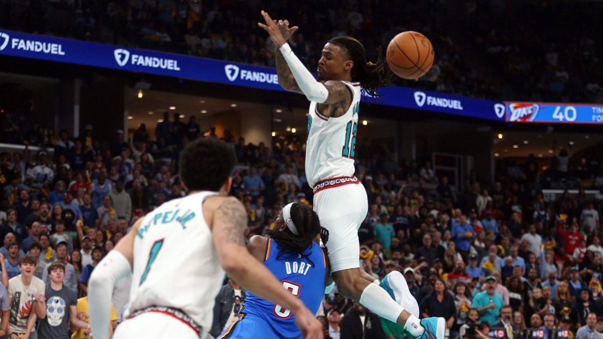 Ja Morant (12) collides with Lu Dort (5) in the play that forced him to leave the game with an injury.