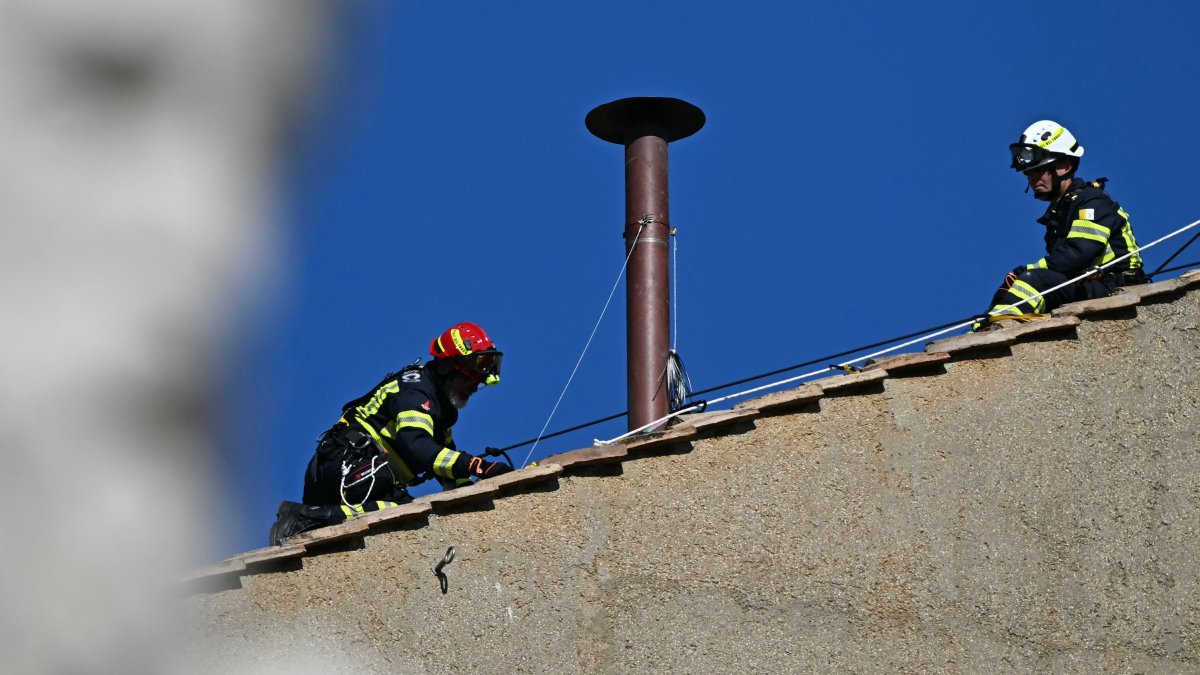 Firemen on the roof of the Sistine Chapel.