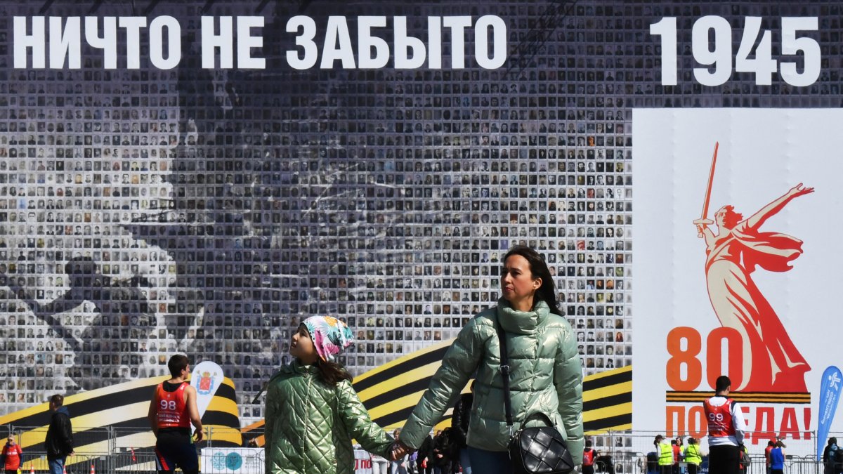 A group of people walk past a giant
