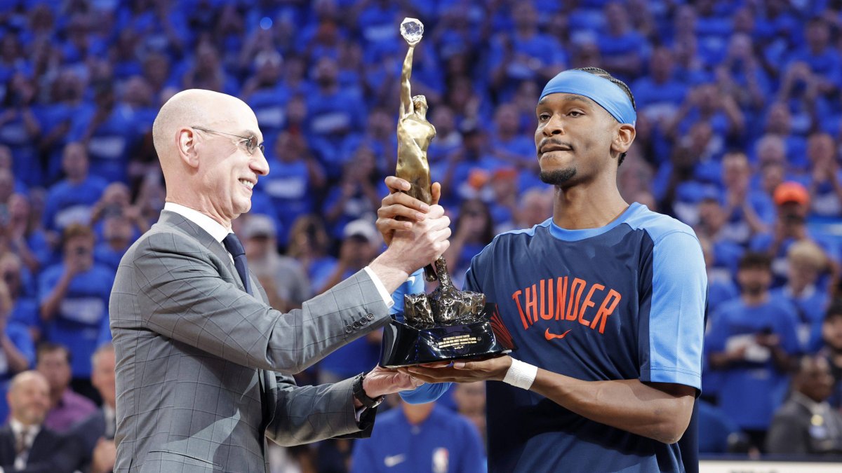 Gilgeous-Alexander receives the MVP award from Adam Silver