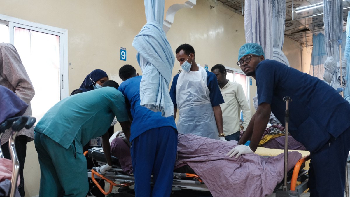A group of health workers tend to a patient at a hospital in Sudan