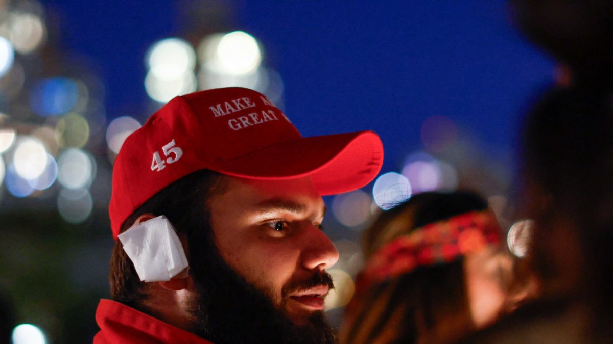 A man wears a MAGA hat and a bandaged ear during New York Young Republican Club's 6th annual MAGAWEEN party.